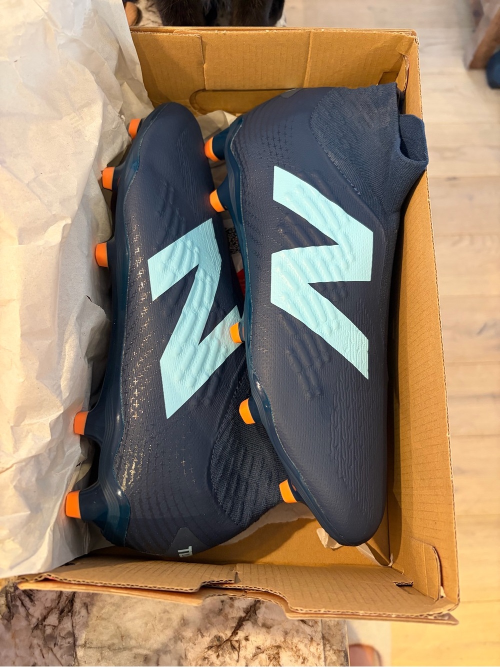 New Balance men’s Navy Soccer Cleats with Light Blue Logo and Orange Studs